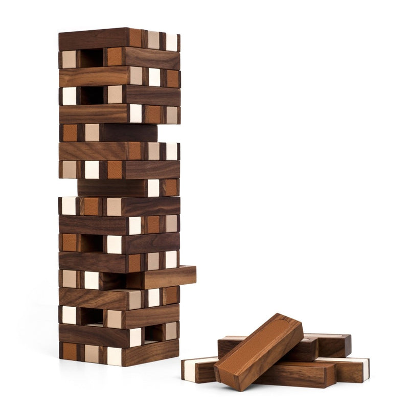 Wooden block tower game with pieces on a white background
