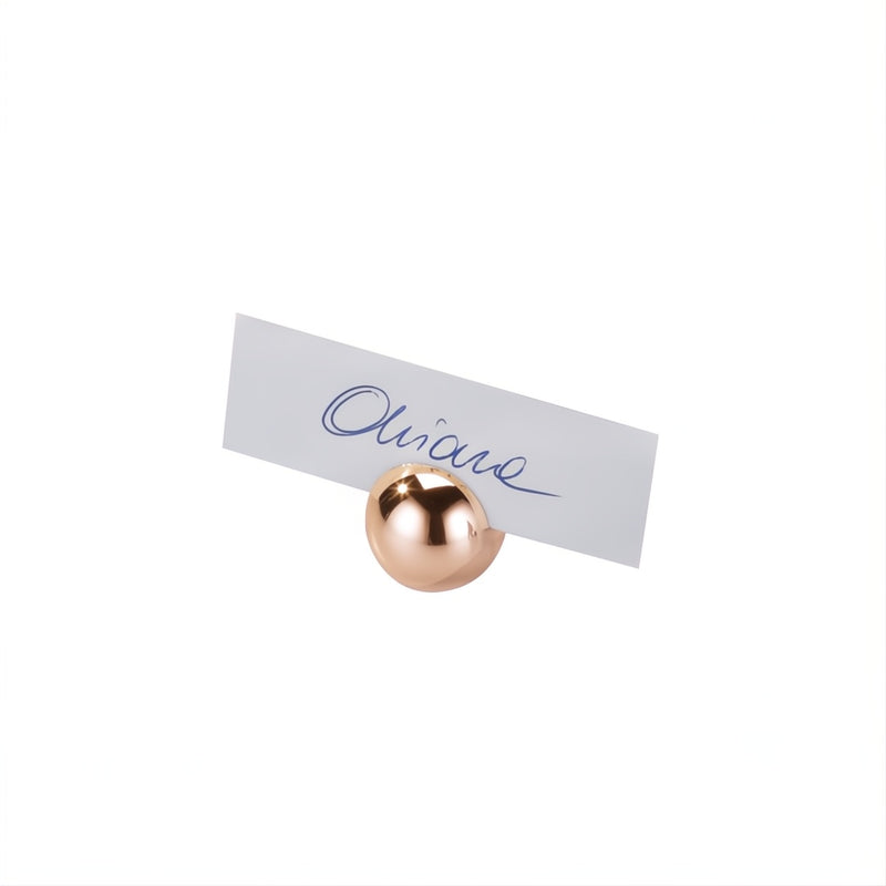 Place card holder with a rose gold ball and 'Olivier' written on a white background