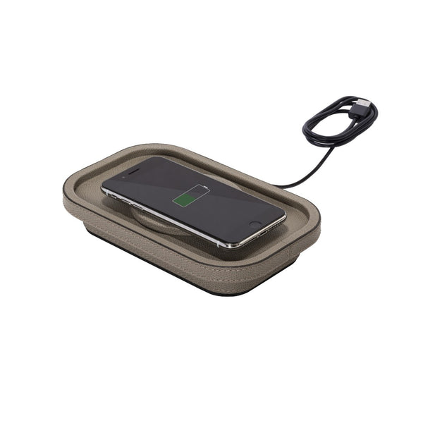 Wireless charging pad with a smartphone on a white background