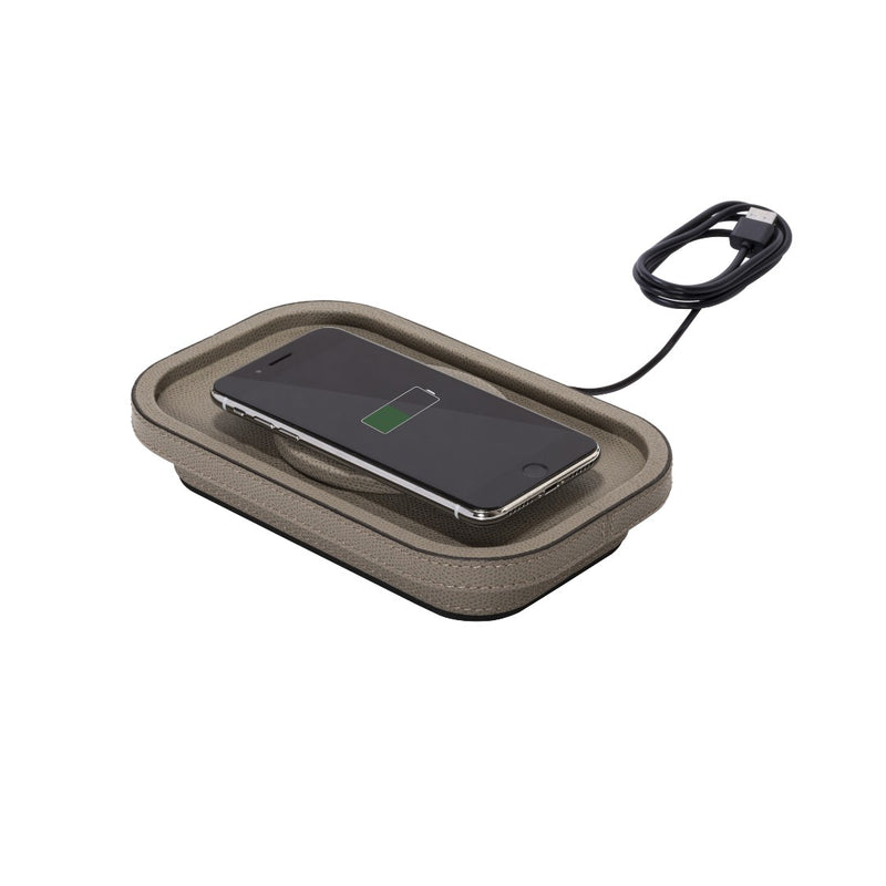 Wireless charging pad with a smartphone on a white background