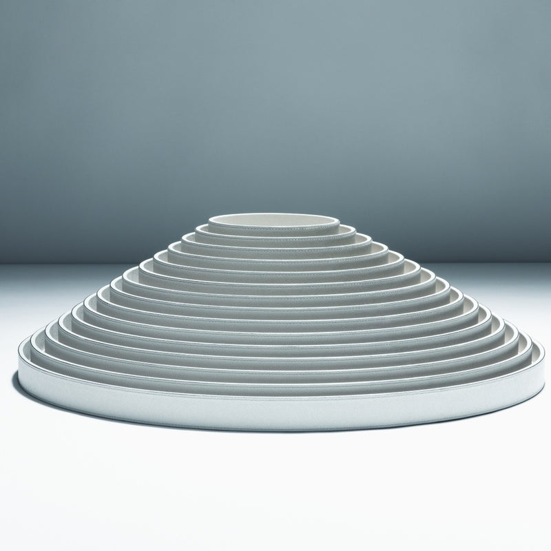 Round Polo Utopia tray in Calfskin Golf leather by Giobagnara, stacked, handcrafted in Italy and available in multiple sizes on a gray background