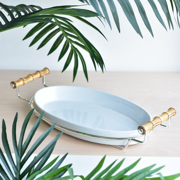 Styled Porcelain oval serving dish from the Linea collection by Schiavon, featuring bamboo handles and a silver-plated stand