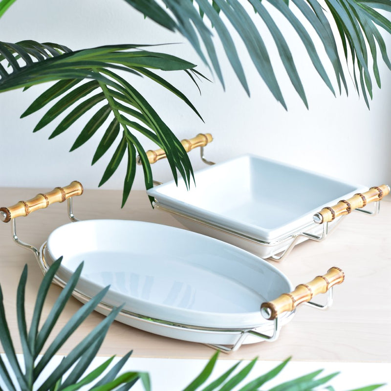 Two Porcelain square and oval salad bowls from the Linea collection by Schiavon surrounded by green leaves.