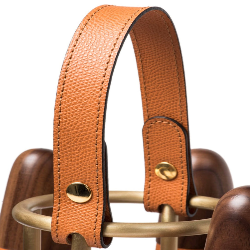 Close-up of a brown leather strap with gold hardware of the Luxury portable bowling set in Canaletto walnut wood with leather and brass details by Pinetti