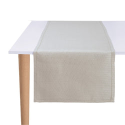 Beige table runner on a white table with wooden legs