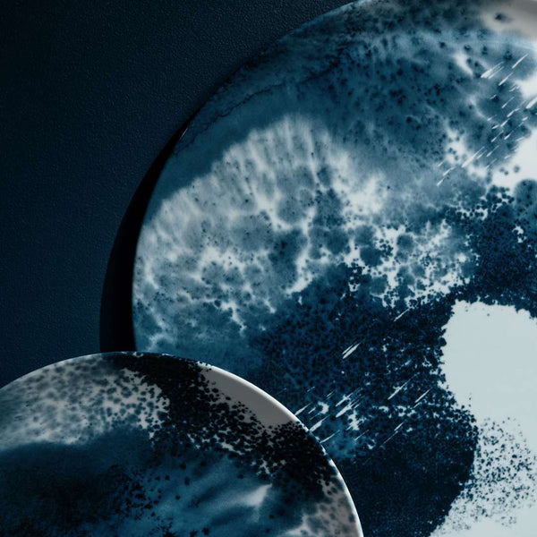 Close-up of charger plate Abysses by Raynaud inspired by ocean depths with a dark background
