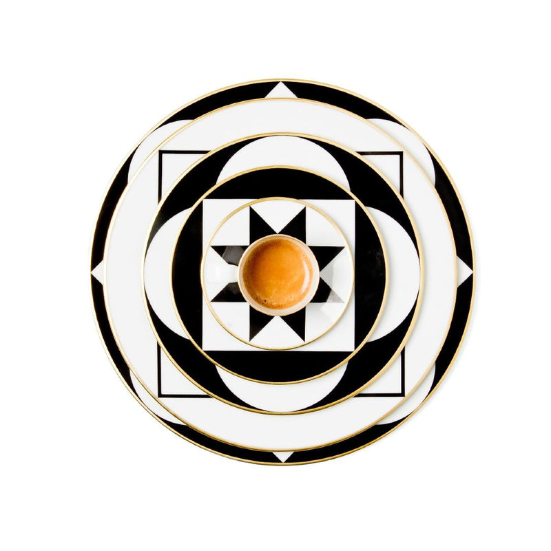 Decorative plate with geometric black and white pattern on a white background