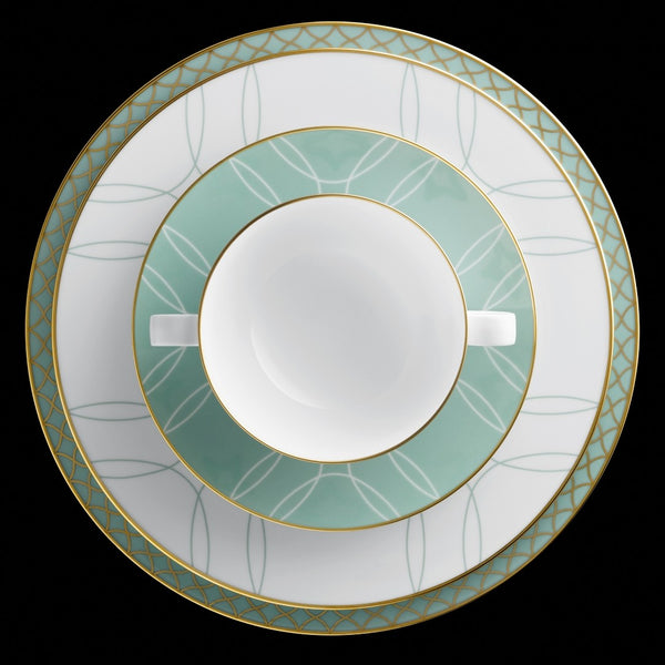 Set of three ceramic plates with green and gold decorative rims on a black background