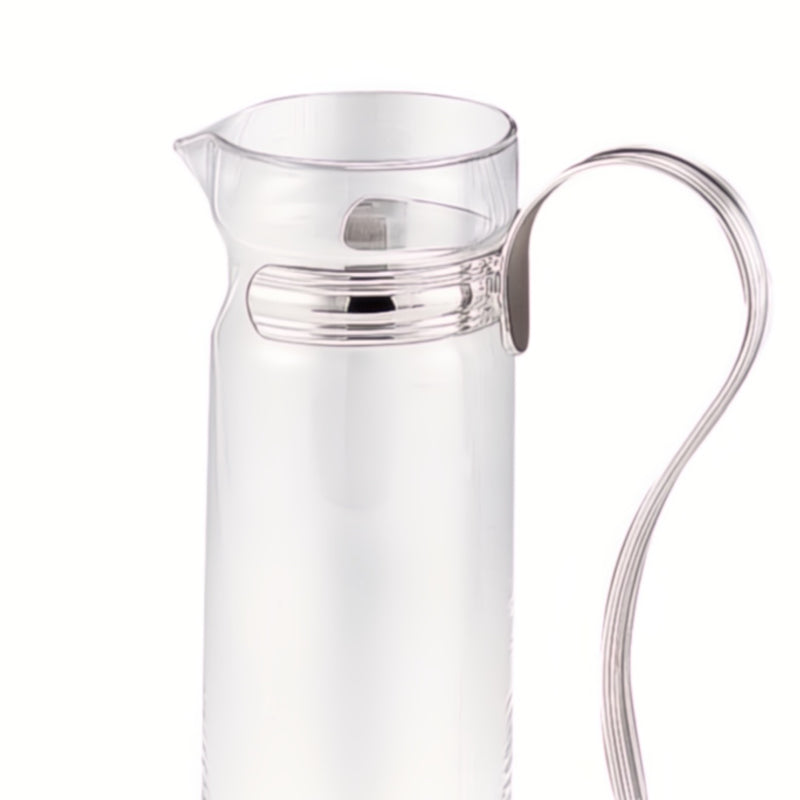 Close-up Luxury prosecco carafe in clear glass with curved silver-plated handle by Greggio – elegant design for fine dining and yacht entertaining.