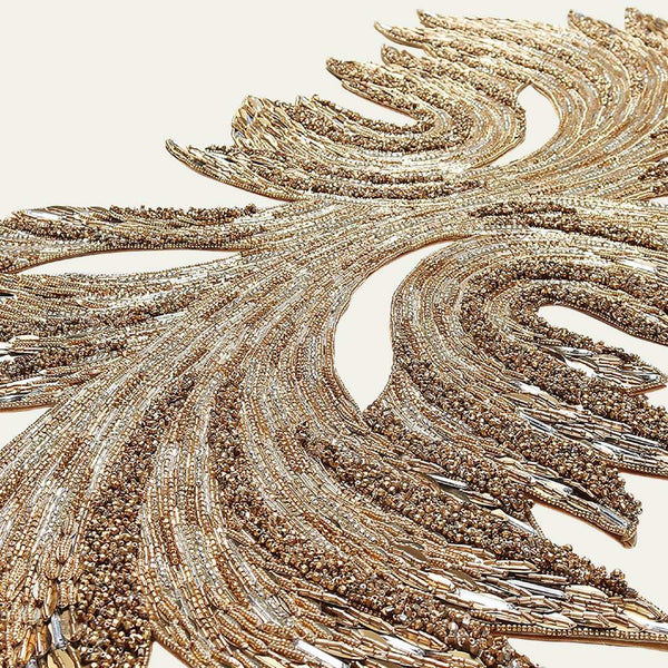 closeup up of a gold and crystal table runner on white background