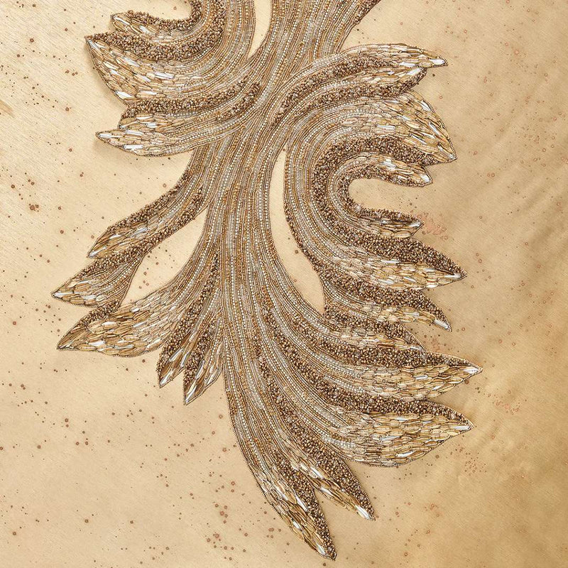 closeup of ray table runner in gold crystals on beige background