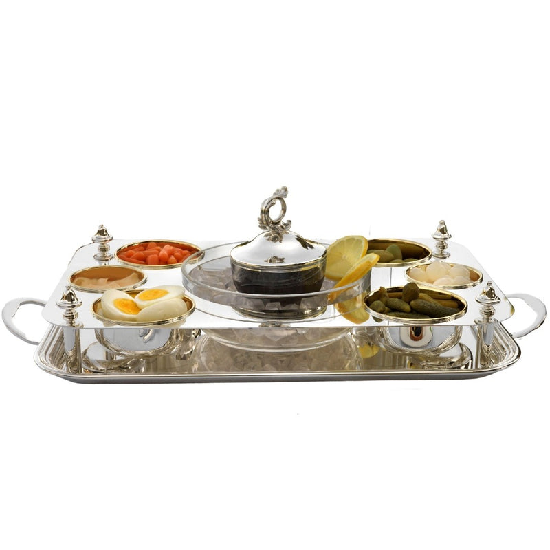 Silver platter caviar server by Greggio with various food items on a white background