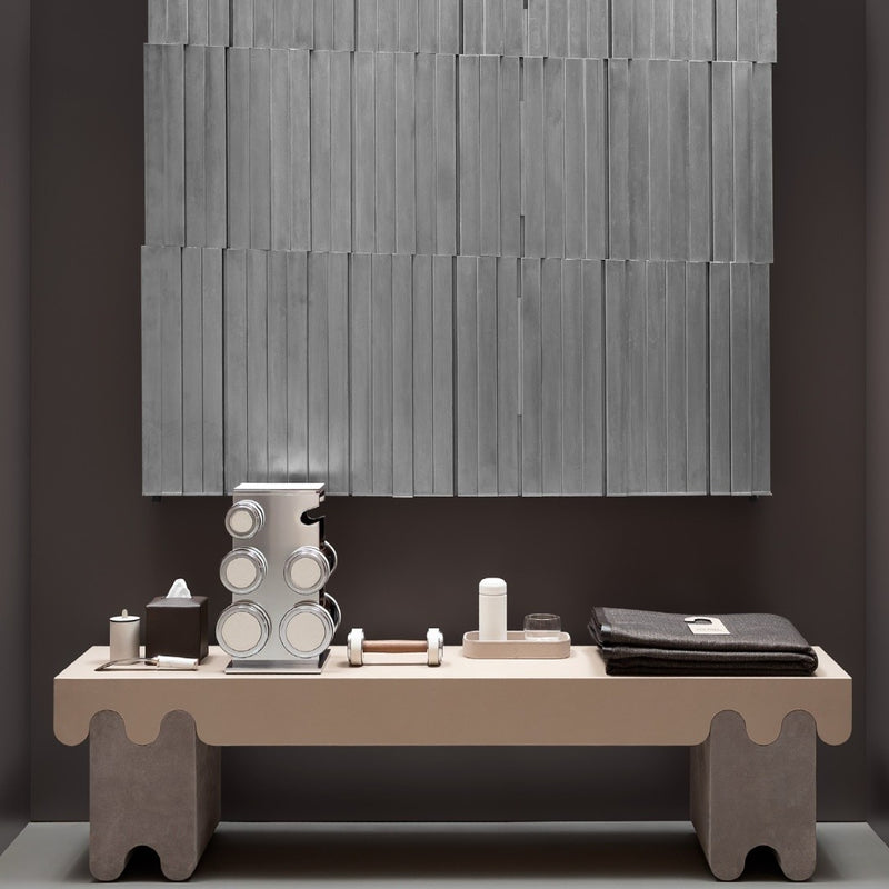 Modern coffee machine on a concrete table with a textured wall in the background