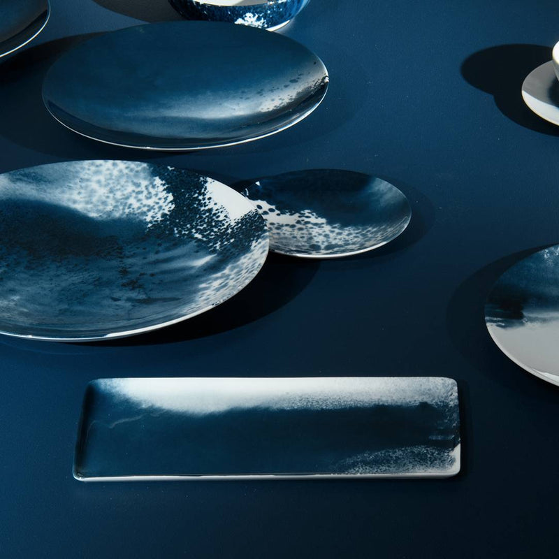 Ocean-inspired rectangular platter Abysses porcelain Raynaud on a dark surface