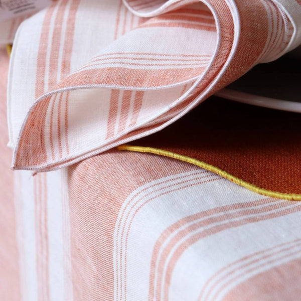 Close-up of a folded fabric with pink and white pattern on a dark surface