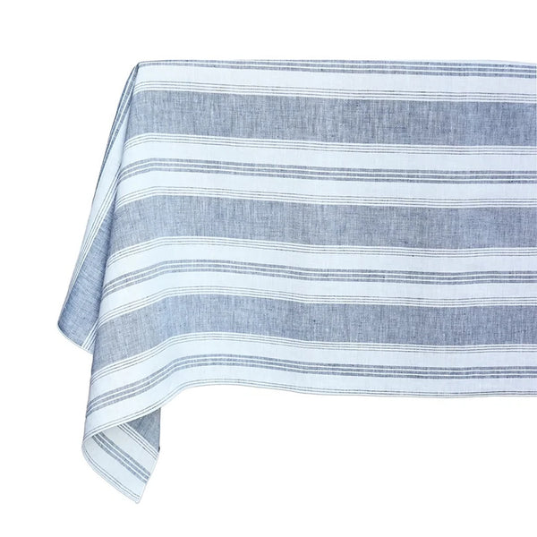 A blue and white striped linen tablecloth on a table, with an irregular stripe pattern.