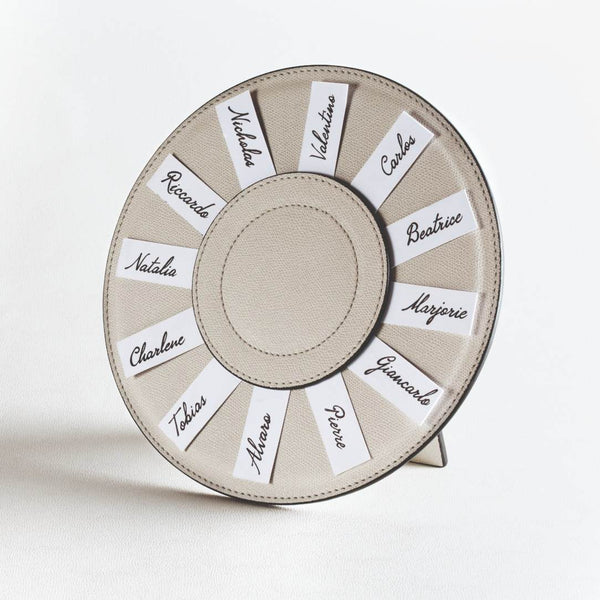 Round Leather Seating Chart Name Holder Aspen by Giobagnara in beige leather with handwritten name cards.