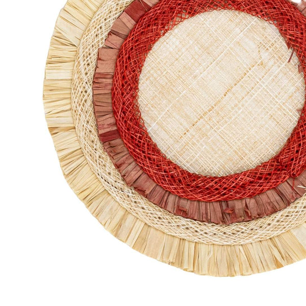 close up of a coaster in red, beige, and brown on a white background