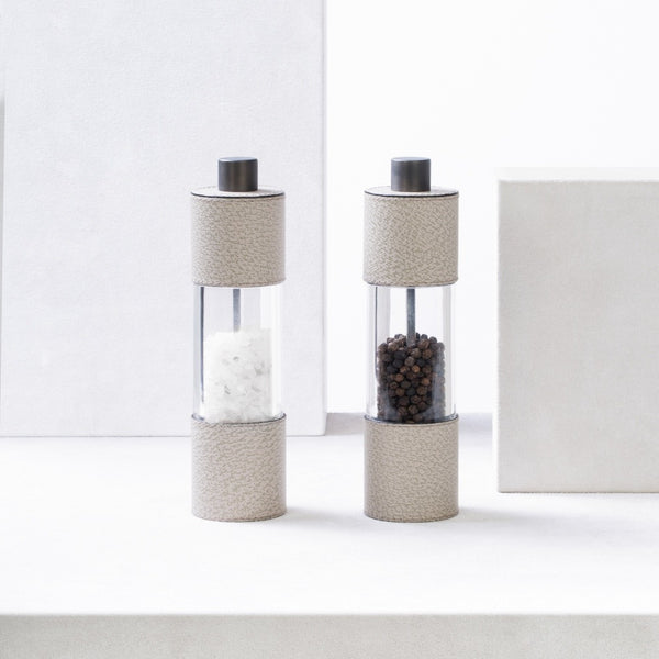 Styled Salt and Pepper Manual Mills Set Otello Tall by Giobagnara in Wild Boar printed leather with adjustable ceramic grinder and metal finishes.