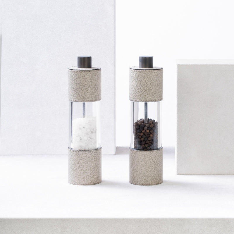 Styled Salt and Pepper Manual Mills Set Otello Tall by Giobagnara in Wild Boar printed leather with adjustable ceramic grinder and metal finishes.