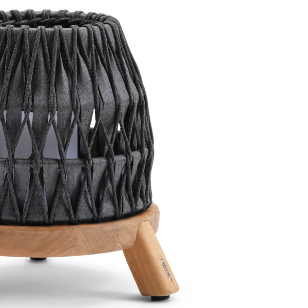 Decorative anthracite woven lantern with wooden legs on a white background