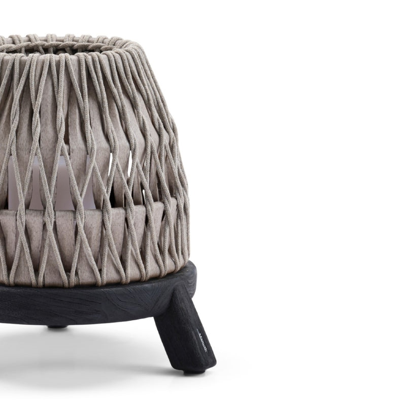 close-up of the Sandua small rechargeable outdoor lantern in grey and black with woven shade and teak base by Manutti on a white background
