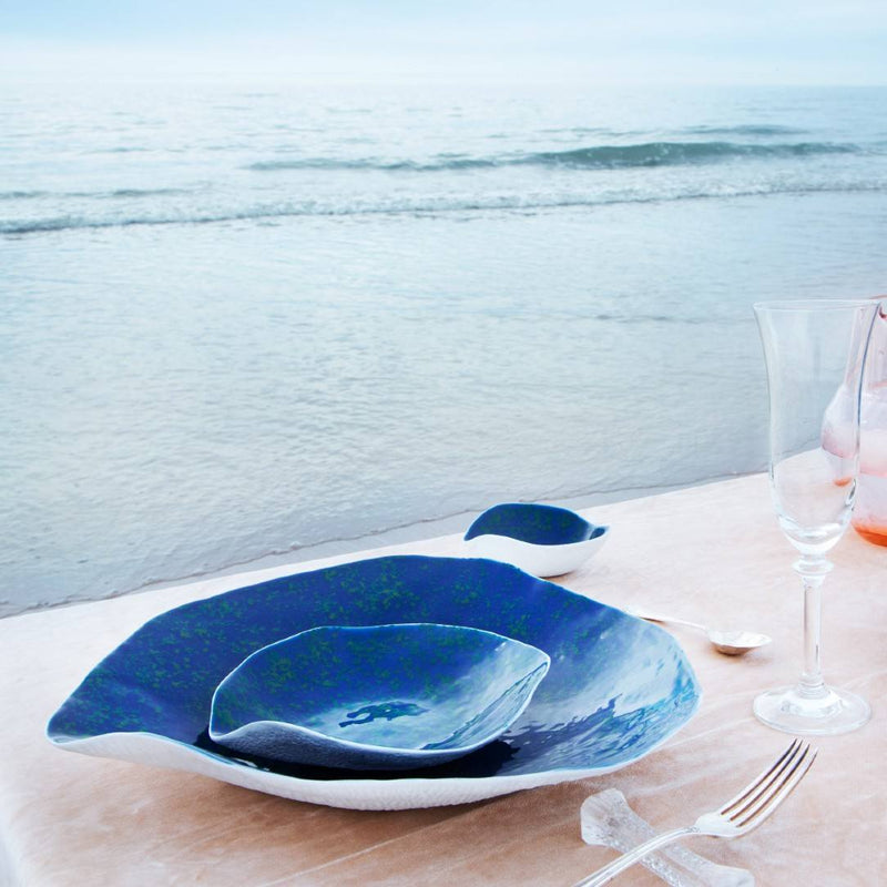 Shell-inspired porcelain large dinner plates Blue Lagoon No6 Indulge on a table with a scenic ocean view in the background