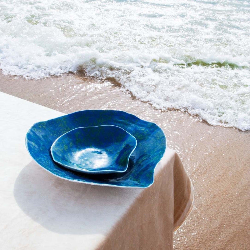 Shell-inspired porcelain large dinner plates Blue Lagoon No6 Indulge on a white surface with ocean waves in the background