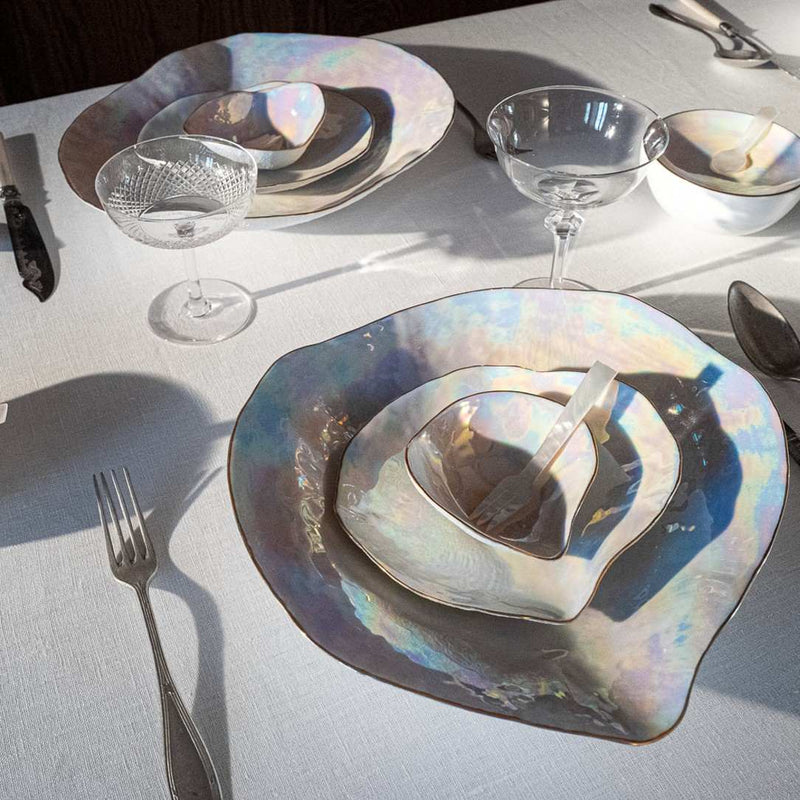 Luxury Limoges porcelain large dinner plates Pearlescent No6 Indulge and glasses on a white tablecloth