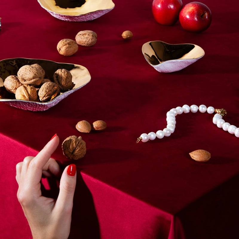 Styled table with Sculptural porcelain side bowls gold Nº2 Indulge Sarah-Linda  on a red tablecloth