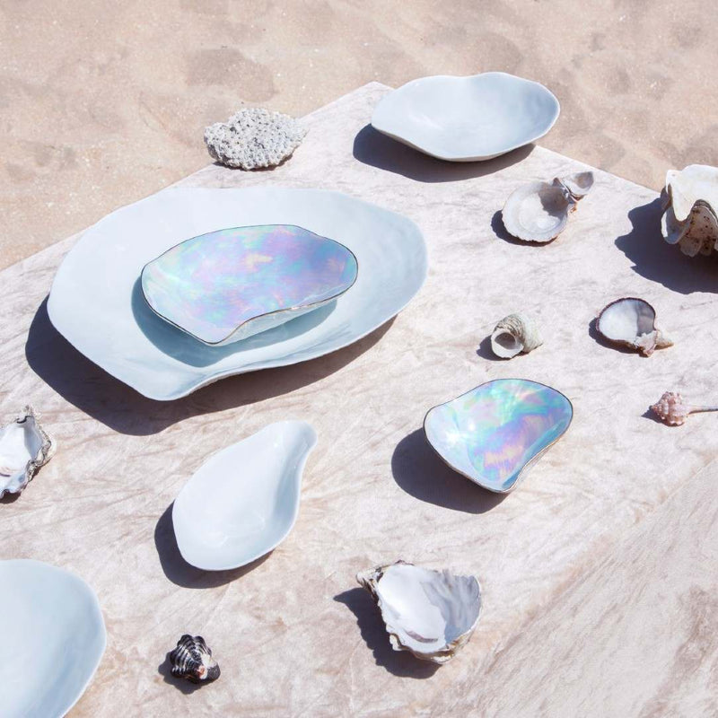 Sculptural porcelain side bowls pearlescent Nº2 Indulge Sarah-Linda on a sandy surface with small shells around