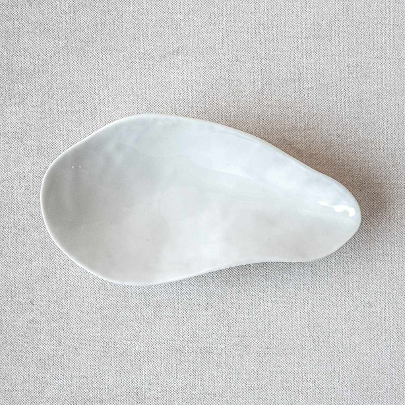 Shell-inspired porcelain side bowls White finish No3 Indulge on a light gray fabric background