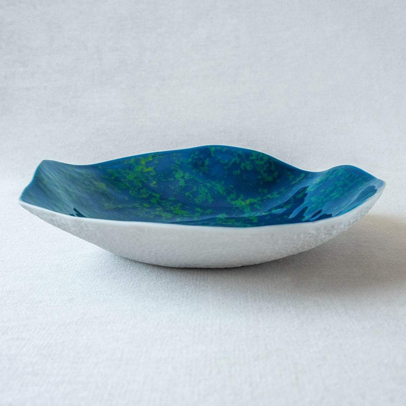 Shell-inspired porcelain small plates ocean blue finish No5 Indulge on a white background