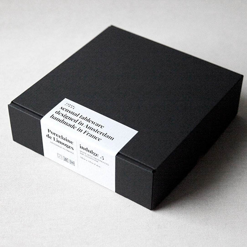 Black box with a white label on a light gray background from Sara-Linda Porcelain