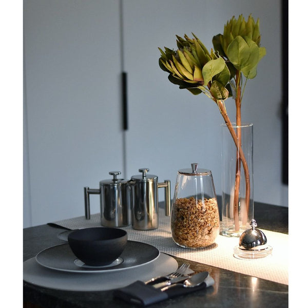 Styled breakfast table with artificial protea stem in green made from waxed silk by Silk-ka, from the Flowers For Life collection by Amiramour.