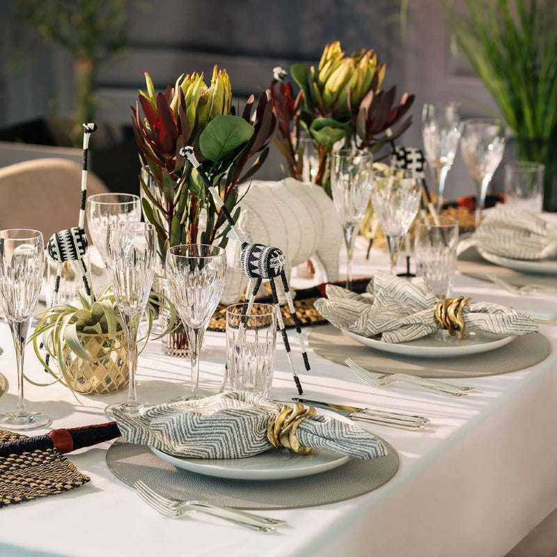 Styled safari themes table with artificial protea stem in green made from waxed silk by Silk-ka