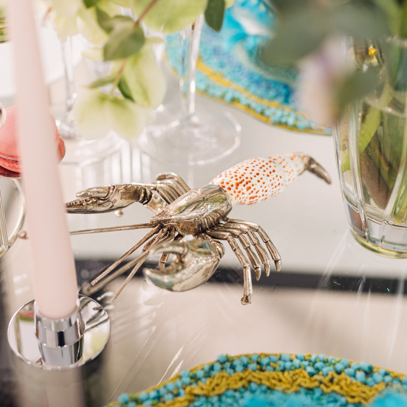 silver plated lobster figurine on table
