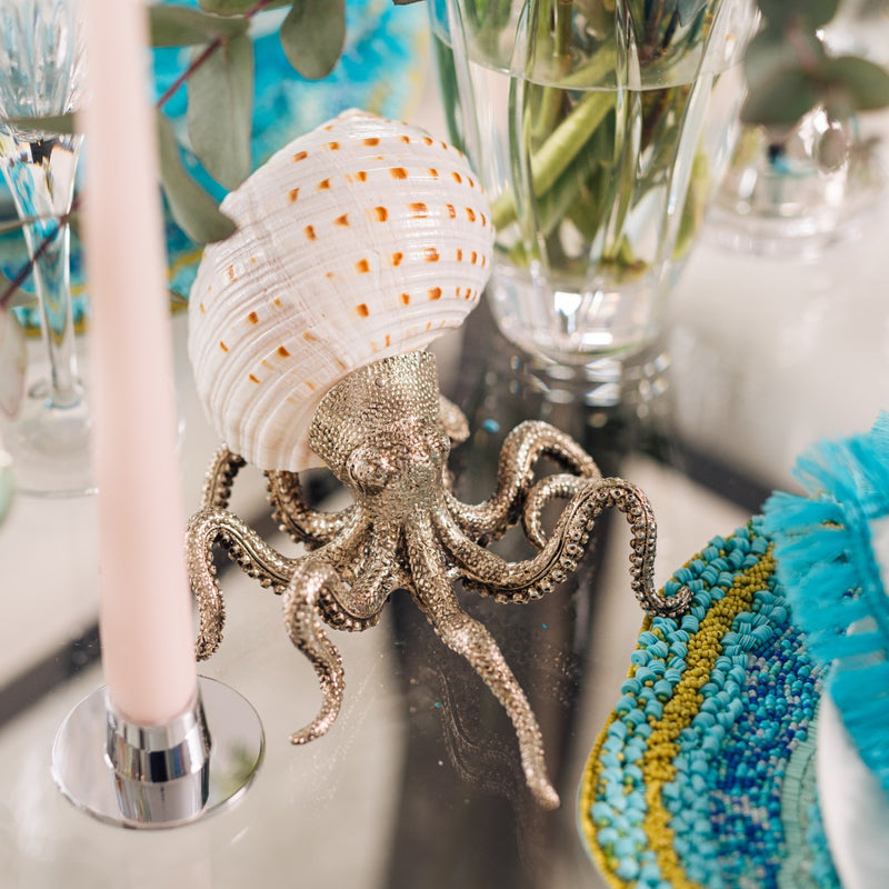 Silver-plated octopus sculpture on styled table