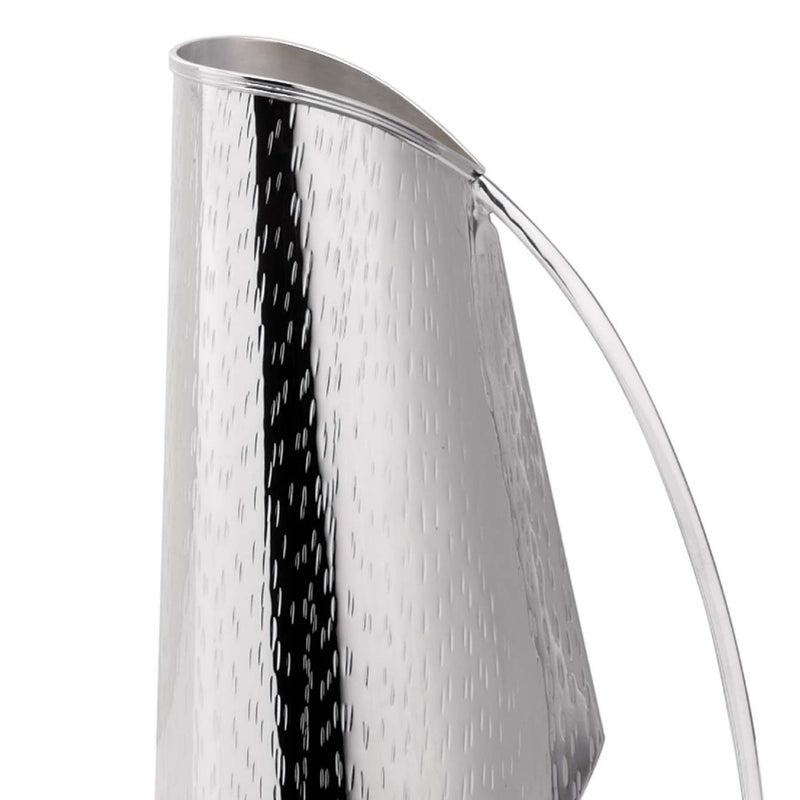 Close-up of silver-plated pitcher Rain by Greggio with sculptural shape and textured finish – handcrafted Italian design for elegant dining and yachts.