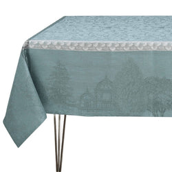 Teal tablecloth with garden scene design on a white background