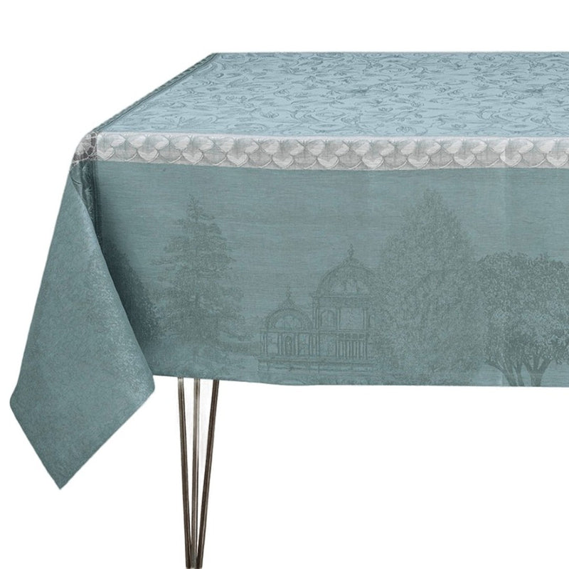 Teal tablecloth with garden scene design on a white background