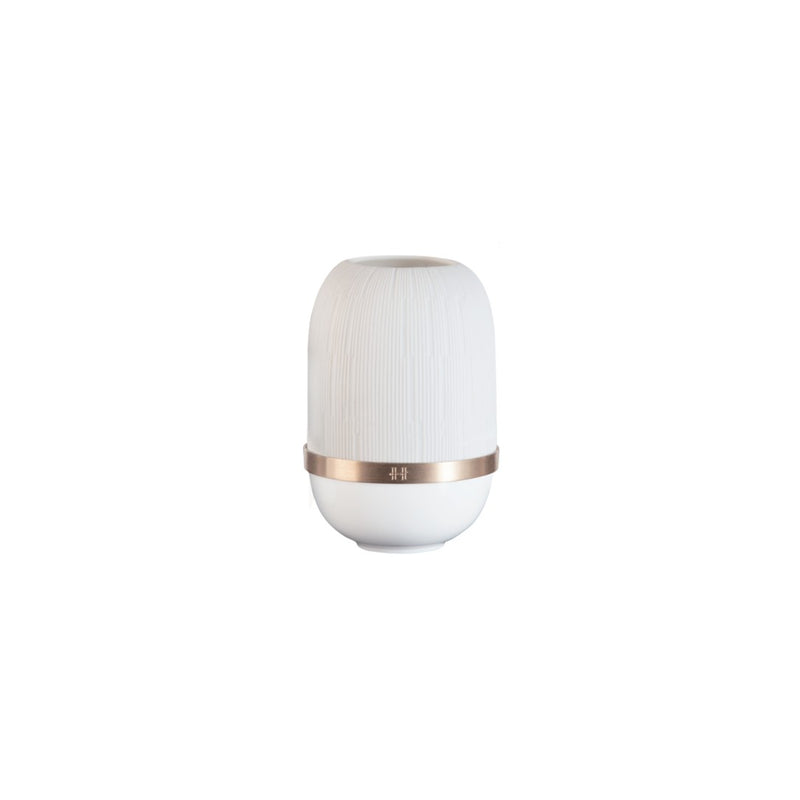 White cylindrical candle holder with gold accent on a white background