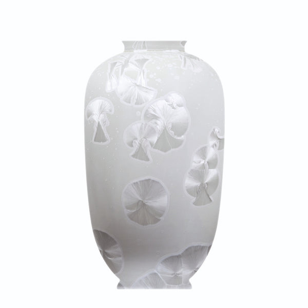 A white porcelain vase with a floral pattern and a matte finish.