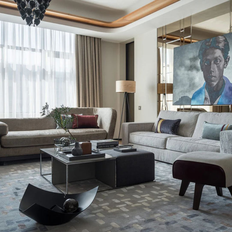 Modern living room with gray sofa, coffee table, and decorative elements.