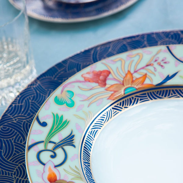 Decorative plate with floral patterns on a blue tablecloth