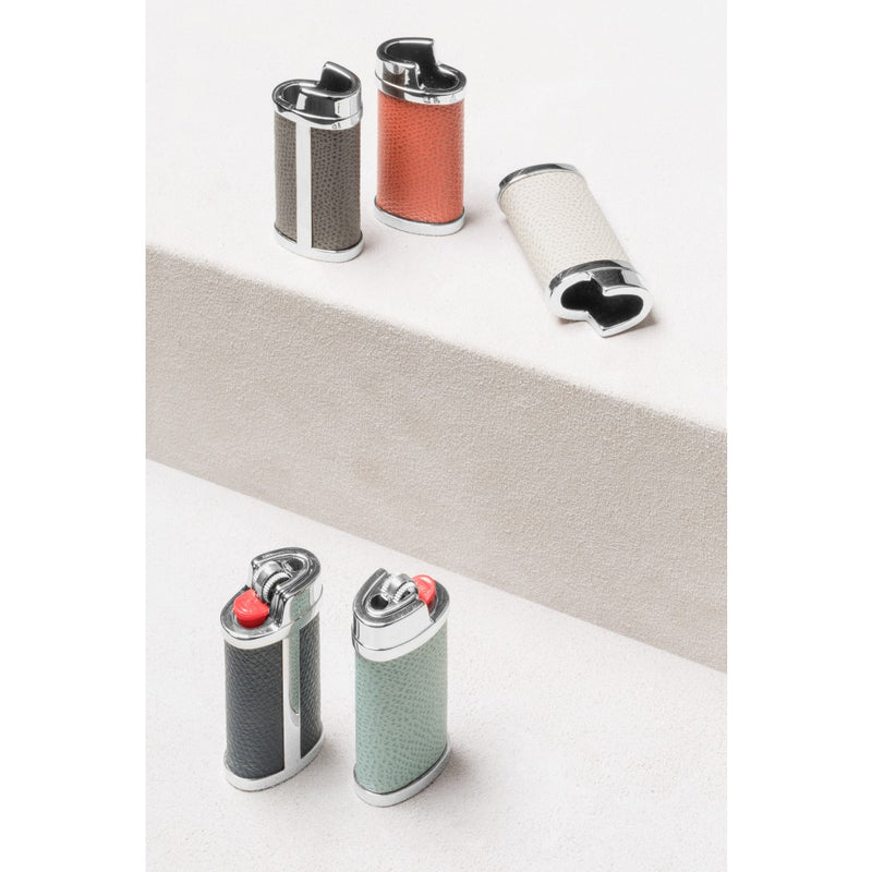 Collection of stylish lighters on a white surface with a neutral background