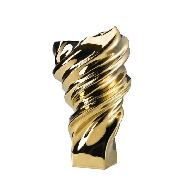 Gold and black twisted jewelry piece on a white background