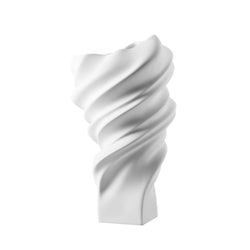 White, twisted ceramic vase on a white background