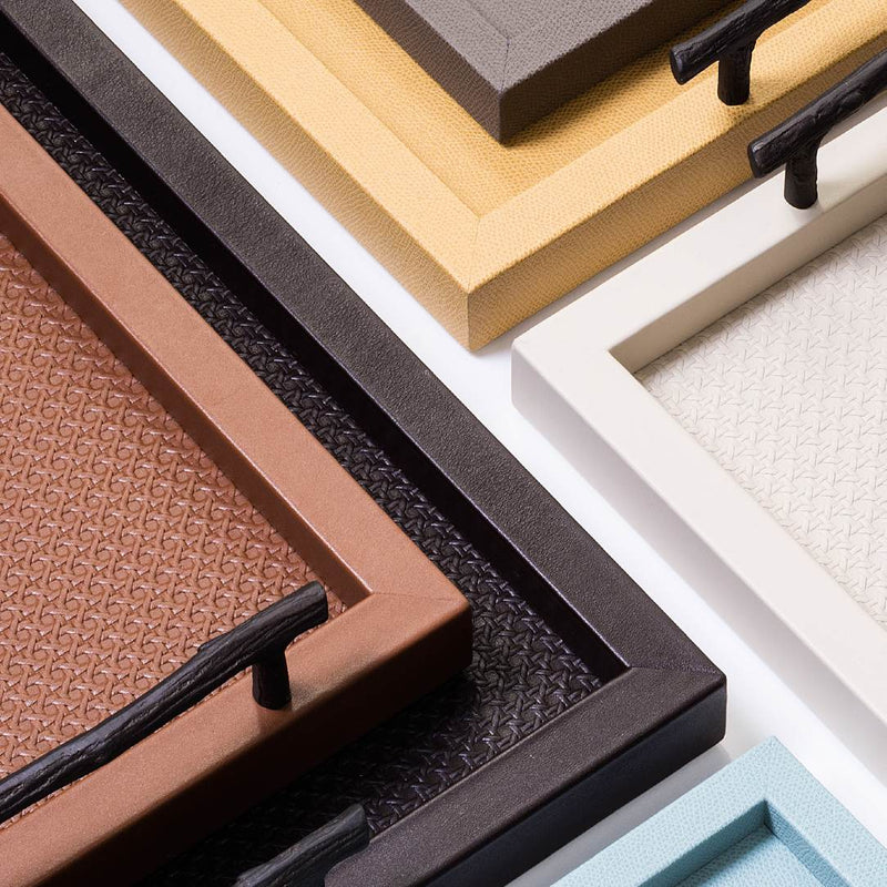 Collection of various Chaumont trays with different leather finishes and colors.