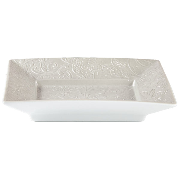 Square porcelain dish with embossed design on a white background